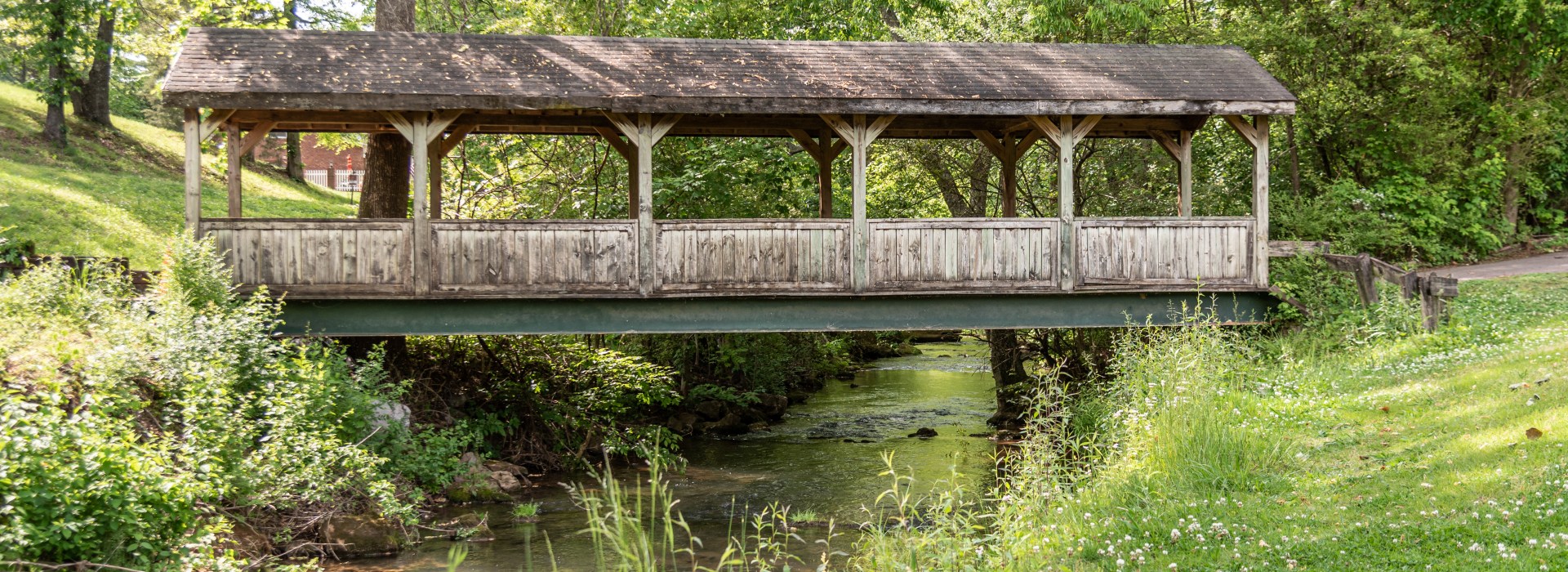 Covered wooden bridge over a lake a the course